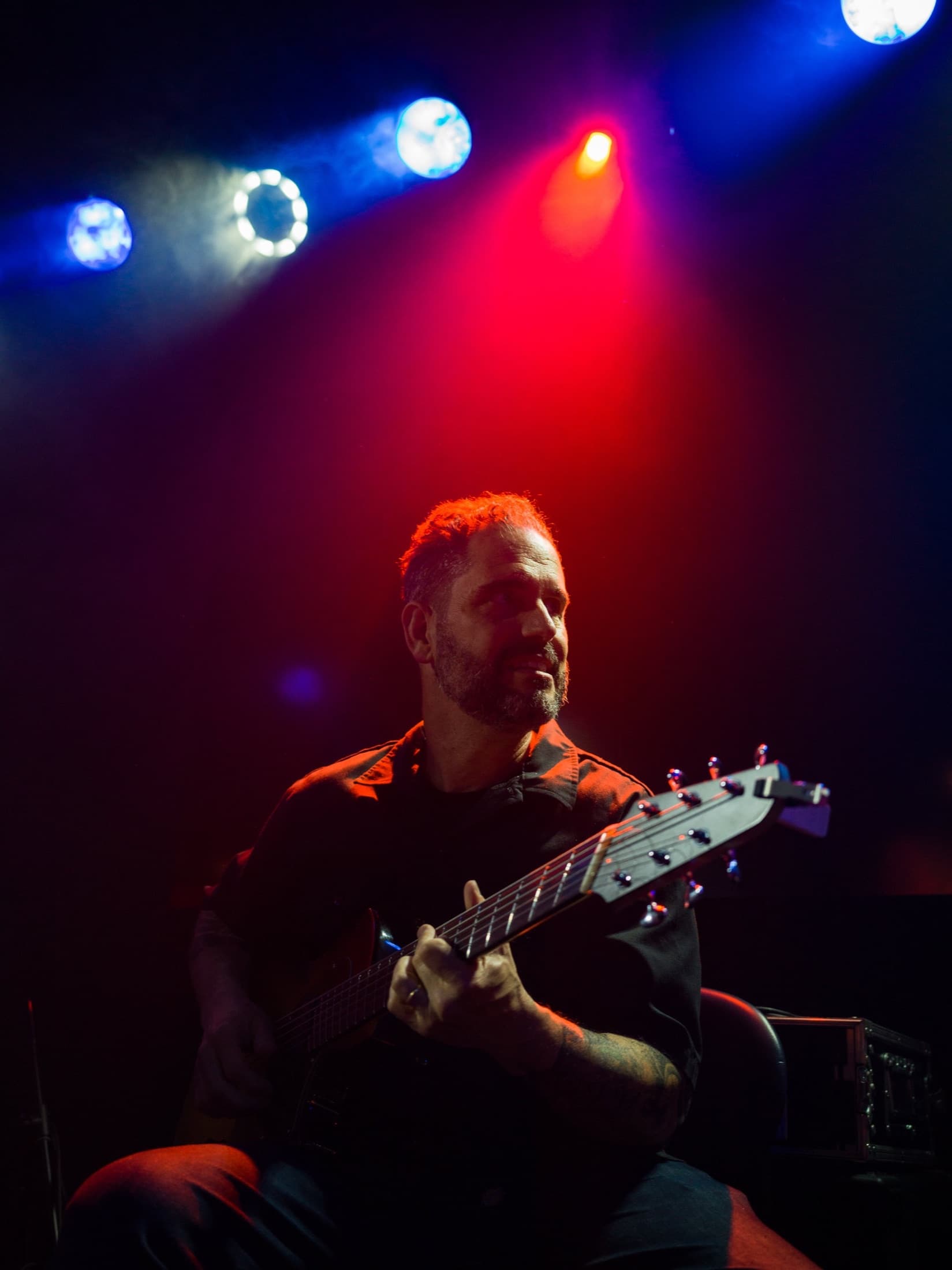 Charlie Hunter on stage in red and blue light